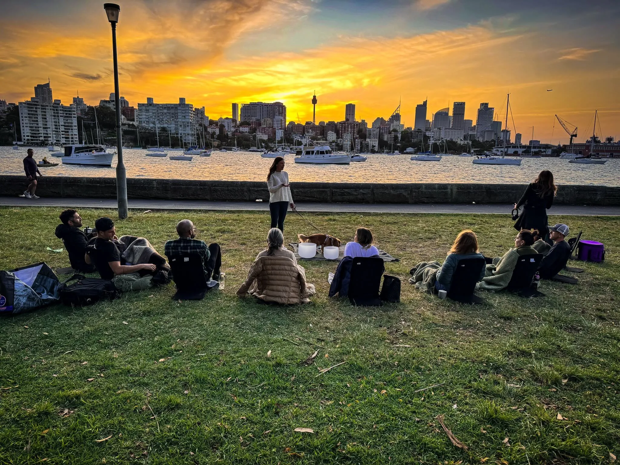 Group sharing ceremonial cacao at sunset, Yarranabbe Park, Sydney harbour
