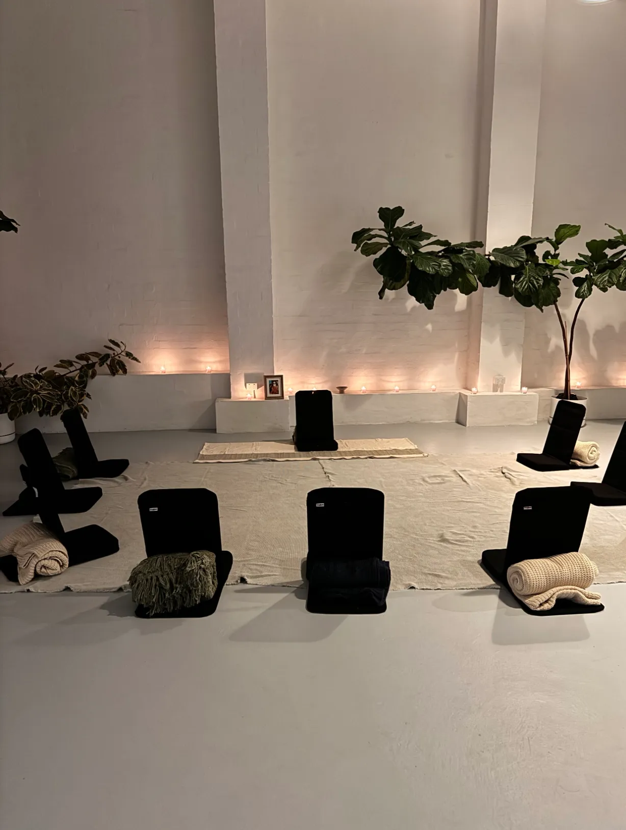 Fortnightly group meditation setup with cushions and candles, Prema studio Sydney