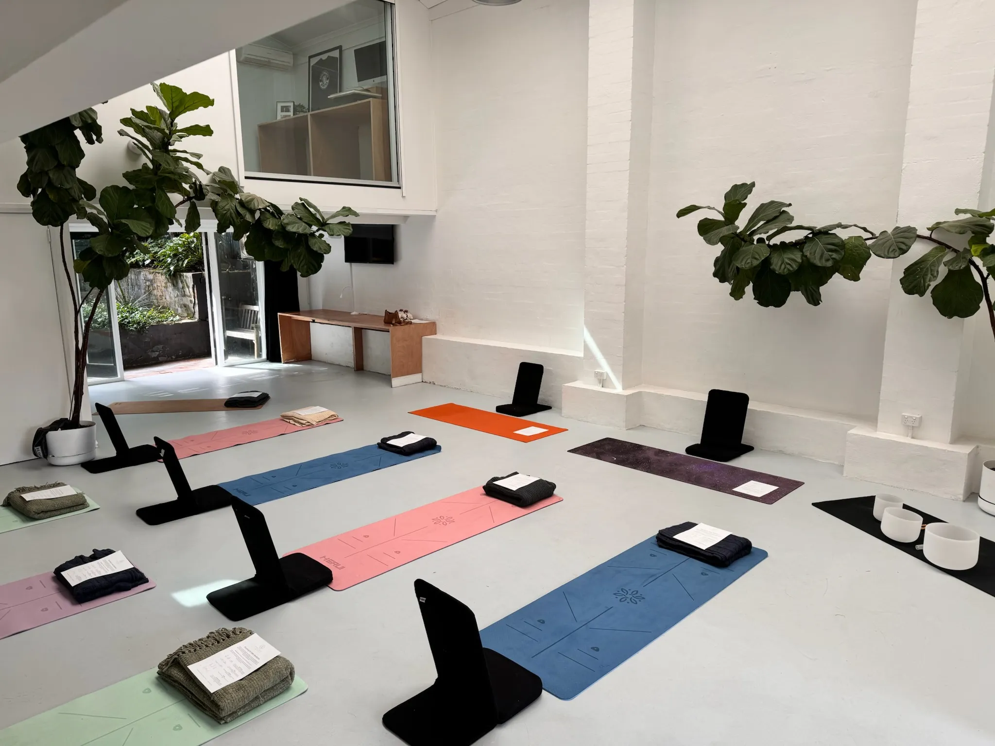 Meditation room set up for Rounding practice, candlelit with floor cushions
